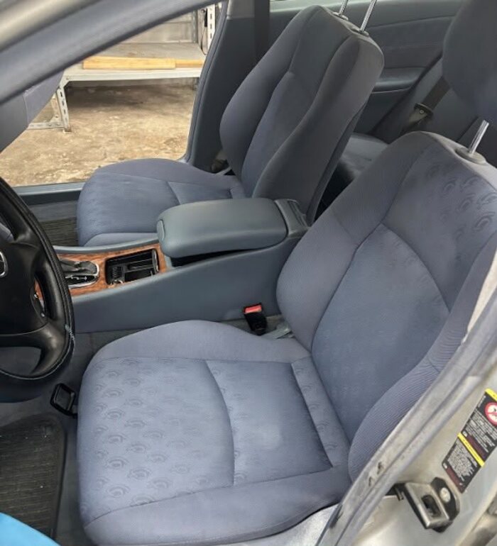 Cleaned fabric seat after professional car cleaning, no stains visible